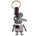Retro robot keychain with woven leather strap and engraved metal charm on white background - Brown