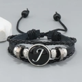 Macro detail of multilayer leather bracelet with silver beads and letter J charm - Letter J