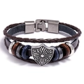 Detail of vintage leather bracelet with shield charm and wooden beads on white background - Wolf Eagle Shield Style / Shield Brown