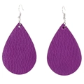 Detail macro view of purple teardrop earrings featuring litchi leather texture and silver hooks - Purple
