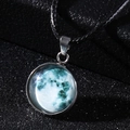 Macro shot of cosmic blue moon glass pendant with wax cord on a starry background - Cyan Planet Style (7*)