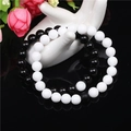 Detail of 8mm black onyx and white stone beaded bracelet set on ceramic hand display - Black and White Set
