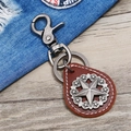 Retro leather keychain with star relief pendant on light wood and denim background - Dark Brown