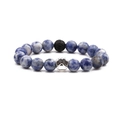 Blue sodalite stone bead bracelet with silver animal paw print charm on white background - Blue Sodalite