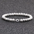 6mm witte turquoise kralenarmband met een witte letter A kraal en zilveren tussenstukjes - 6mm Imitatie Wit Turkoois
