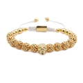 Detail of adjustable woven bracelet featuring a gold skull charm and micro zircon beads - Skull