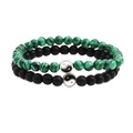 Matching turquoise and lava stone bracelets with yin yang charms on a white background - Green Peacock Stone
