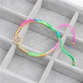 Detail of rainbow braided bracelet with colorful zircon butterfly pendant and gold beads - Dainty Zircon Butterfly