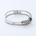 Detailed macro view of silver titanium steel bangle with sliding rings and inset crystals - Steel Color (sz591)