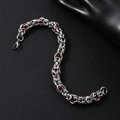 Detailed close-up of Byzantine style silver chain with red beads and lobster clasp - Red Stone