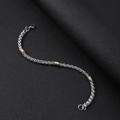 Detailed macro view of 5mm stainless steel dragon bone chain with golden beads and lobster clasp - Bracelet 21CM / Silver and Gold