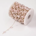 Detail view of pink gemstone and pearl DIY jewelry chain on a white storage spool - 18# Peach