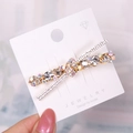 Elegant gold X-shaped hair clip with sparkling rhinestones on jewelry card - K9 / White