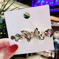 Elegant gold hair clip with grey crystal butterfly design on jewelry display card - Gray