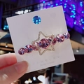 Pince à cheveux étoile rose avec cristaux et accents argentés sur carte de bijoux - Violet