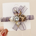 Purple organza bow hair clip with central rhinestone and leopard print bead detail - Purple