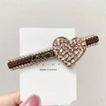 Brown braided rope hair clip featuring a rhinestone heart with Loveme text engraving - Champagne