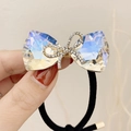 Bow hair tie featuring iridescent crystals and sparkling rhinestones on a gold base - Single Layer Rhinestone Bow / Moonlight White