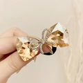Elegant black hair tie with champagne crystal bow and diamond-encrusted center accent - Single Layer Rhinestone Bow / Champagne