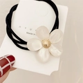 Black elastic hair tie with pearlescent white flower charm and golden center - White Cat's Eye Flower