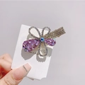Detailed close-up of a purple crystal butterfly hair clip with sparkling silver rhinestones - Purple