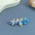 Barrette à cheveux fleur en strass brillants avec gemmes bleues sur base dorée - Bleu