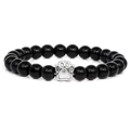 Macro view of 10mm black polished beads with silver paw print charm detail - Glossy Black Stone Bracelet