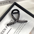 Macro shot of black crisscross hair claw clip with rhinestones and metal spring detail - 8CM Black Black Stone