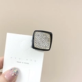 Detailed macro view of square rhinestone hair claw clip on white display card - Square Black White Stone