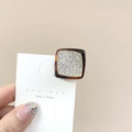 Close-up of a small round tortoiseshell resin hair claw clip with pavé rhinestones - Square Coffee White Stone