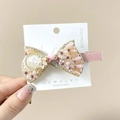 Close-up of elegant hair clip with pink crystals, white pearls and floral details - Bow Pink Duckbill Clip