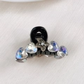 Macro shot of mini hair claw with iridescent heart crystals and floral center detail - Four Leaf Flower Crystal