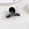 Detail of a mini black hair claw clip featuring elegant grey rhinestones on silk - Rhinestone Ball Cup