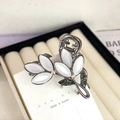 Macro detail of cat-eye flower hair claw with green crystals and black metal plating - Maple Leaf Grey Rhinestone