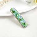 Detail of vintage hair clip with olive green crystals and rhinestones on light blue base - Style 1 / Green