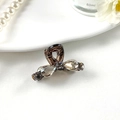 Detail shot of mini rhinestone bow hair claw clip in dark grey metal finish - Style 2 Brown