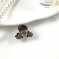 Dettaglio macro della molletta a cuore con strass scintillanti e base in resina marrone - Cuore Marrone