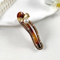 Detailed close-up of tortoise shell hair clip with golden crystal bow and pearl accents - Leopard Print