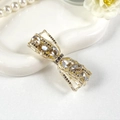 Elegant gold bow hair clip with champagne crystals and grey rhinestones in a tray - Waterdrop Style Grey