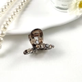 Detail view of amber resin hair claw clip with sparkling rhinestones and elegant pearls - Bowtie Brown Base Coffee Pearl