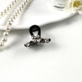 Detailed view of elegant black hair claw clip with rhinestones and faux pearls - Bowtie Black Base Gray Pearl