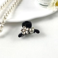 Detail of elegant black hair claw clip with large pearl and rhinestone flower on white plate - Plum Blossom Black Base Gray Pearl