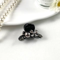 Close-up of sparkling rhinestone hair claw clip with elegant crystal flower detailing - Butterfly Pearl Black