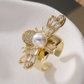 Macro shot of gold bee ring detailing white pearl and zircon wings on polished metal - Gold Pearl Bee(14814)