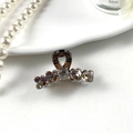 Elegant mini hair claw clip with vintage rhinestones and amber accents on ceramic tray - Elegant Tea With Coffee Flower