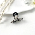 Elegant black hair claw clip featuring sparkling grey rhinestones in a floral pattern - Curved Black