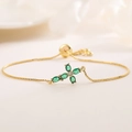 Close-up of adjustable 18K gold chain with a green zircon cross pendant for women - Dainty Green Zircon Cross (32066)