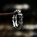 Macro shot of gothic stainless steel skull ring band with vintage oxidized finish - US Size 7 / Steel