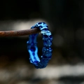 Macro shot of blue electroplated stainless steel skull ring on rustic chain wire - US Size 7 / Blue