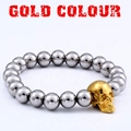 Punk style stainless steel beaded bracelet featuring a striking gold skull charm detail - 18cm / Gold